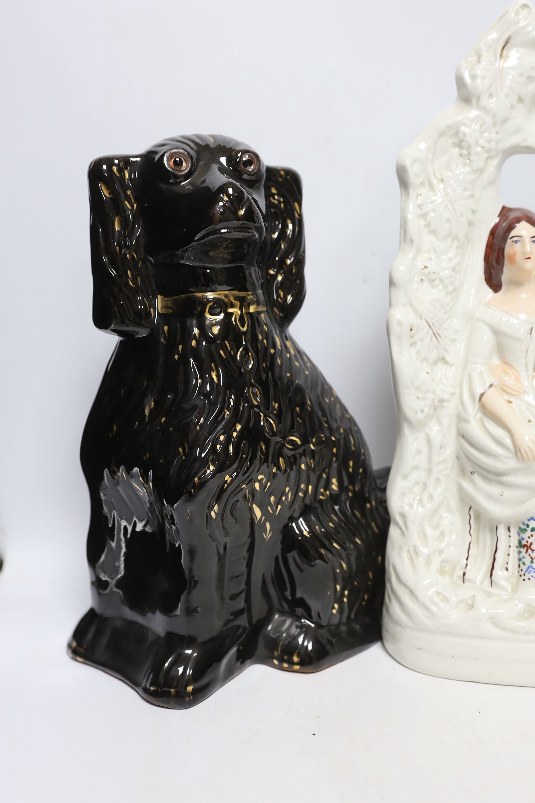 A Staffordshire watch-stand figural group, pair of comforters and two others, largest 34cm high